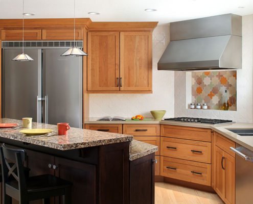 A traditional kitchen in Palo Alto adds a twist, with two tones of wood between the cabinetry and island.