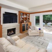 Indoor-outdoor living with built-in bookshelves and fireplace