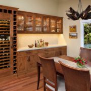 A dining room with a bar and wine storage.