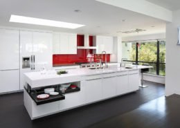 An über-modern Los Altos Hills kitchen is sleek, with a bold pop of color on the backsplash.