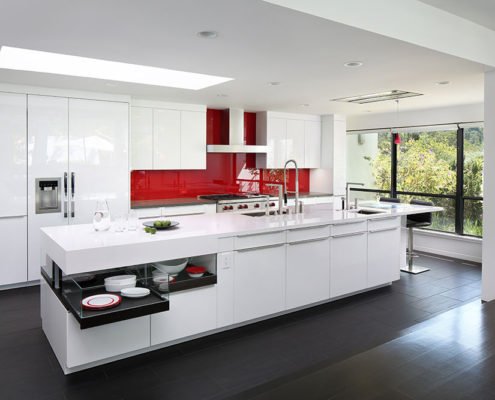 An über-modern Los Altos Hills kitchen is sleek, with a bold pop of color on the backsplash.