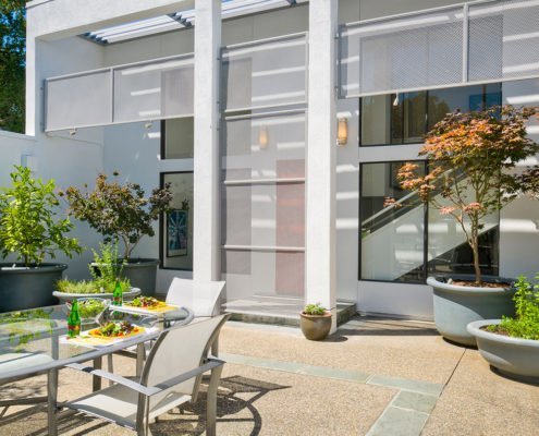 The rear of a modern Los Altos Hills home offers room to dine and relax.