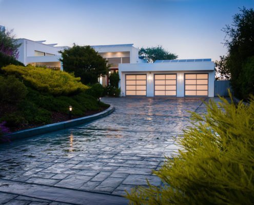 A stone paved driveway leads up to an über-modern white house in Los Altos Hills.