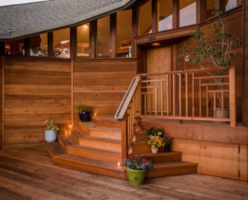 Redwood decking and intricate redwood railing in the front of a home in Redwood City.