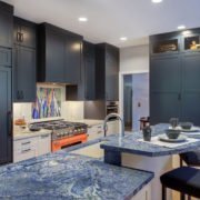 A Palo Alto kitchen using complementary colors, with blue cabinetry and a bright orange stove.