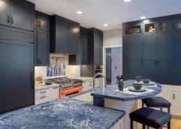 A Palo Alto kitchen using complementary colors, with blue cabinetry and a bright orange stove.