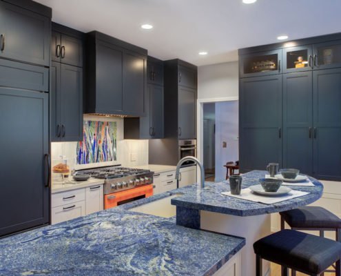 A Palo Alto kitchen using complementary colors, with blue cabinetry and a bright orange stove.