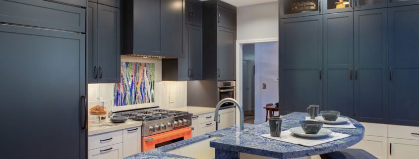 A Palo Alto kitchen using complementary colors, with blue cabinetry and a bright orange stove.