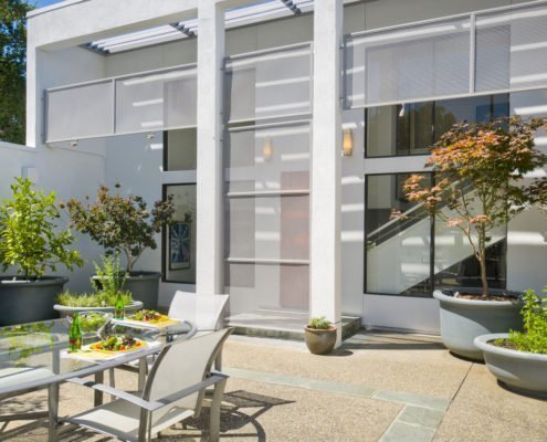 outdoor seating next to glass exterior of house