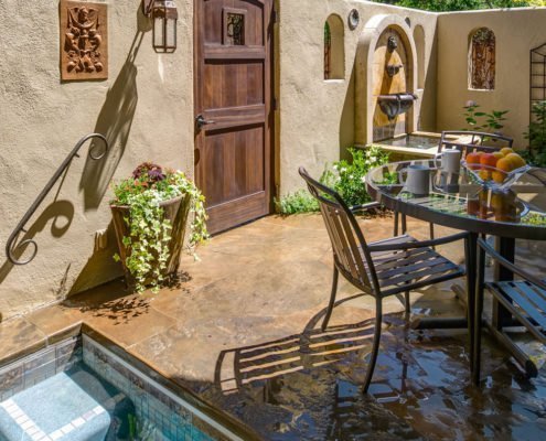 outdoor seating with wooden door and pool