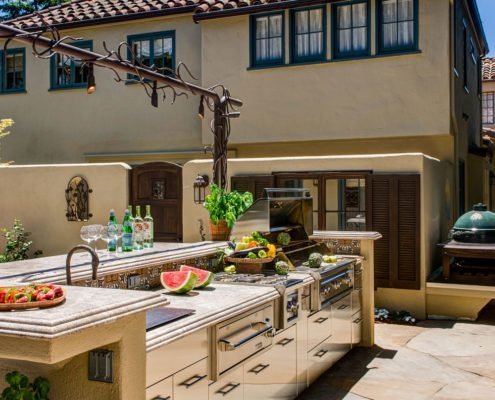 A Spanish style home in Palo Alto has an outdoor kitchen with a grill.