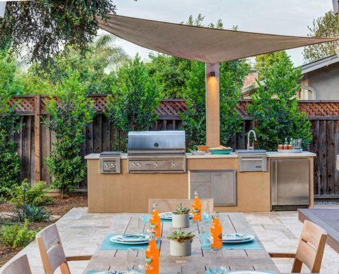 built-in grill next to outdoor kitchen table