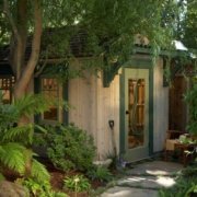 Shed hidden by lush greenery