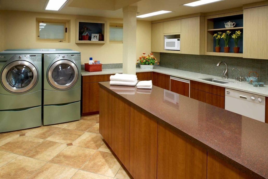 A laundry room with plenty of space for garment care and folding.