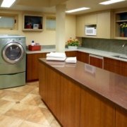 A laundry room with plenty of space for garment care and folding.