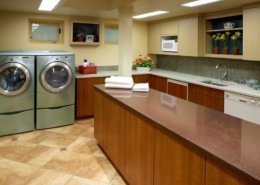 A laundry room with plenty of space for garment care and folding.