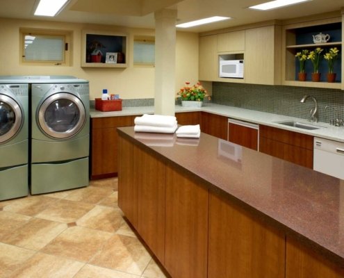 A laundry room with plenty of space for garment care and folding.