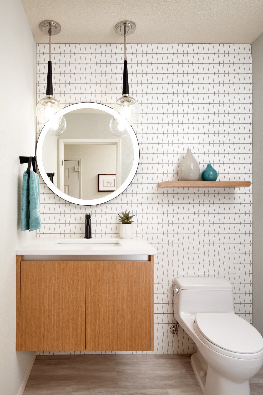 Bright white bathroom with wooden drawers and shelving
