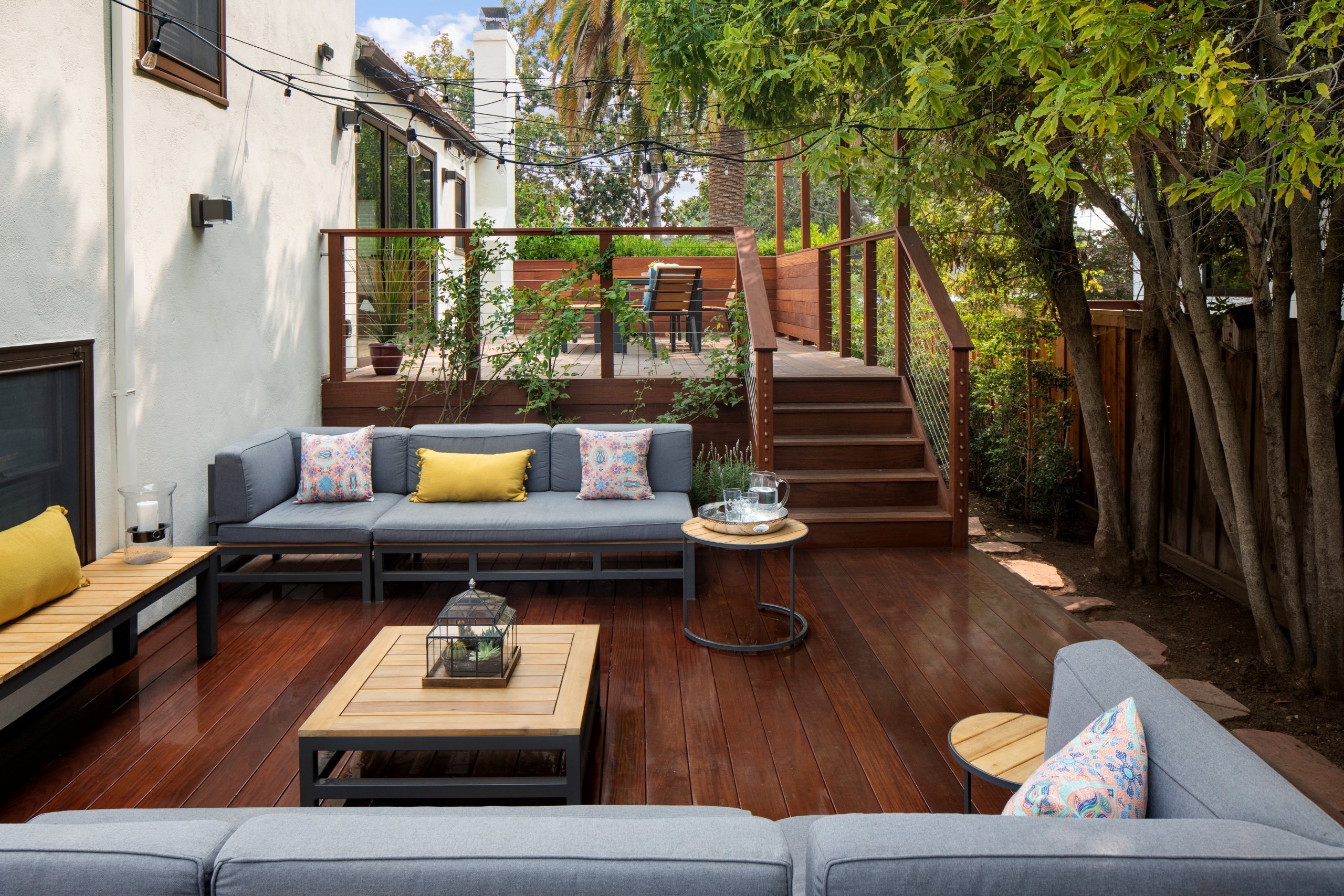 Comfortable couches in outdoor seating area on wooden deck