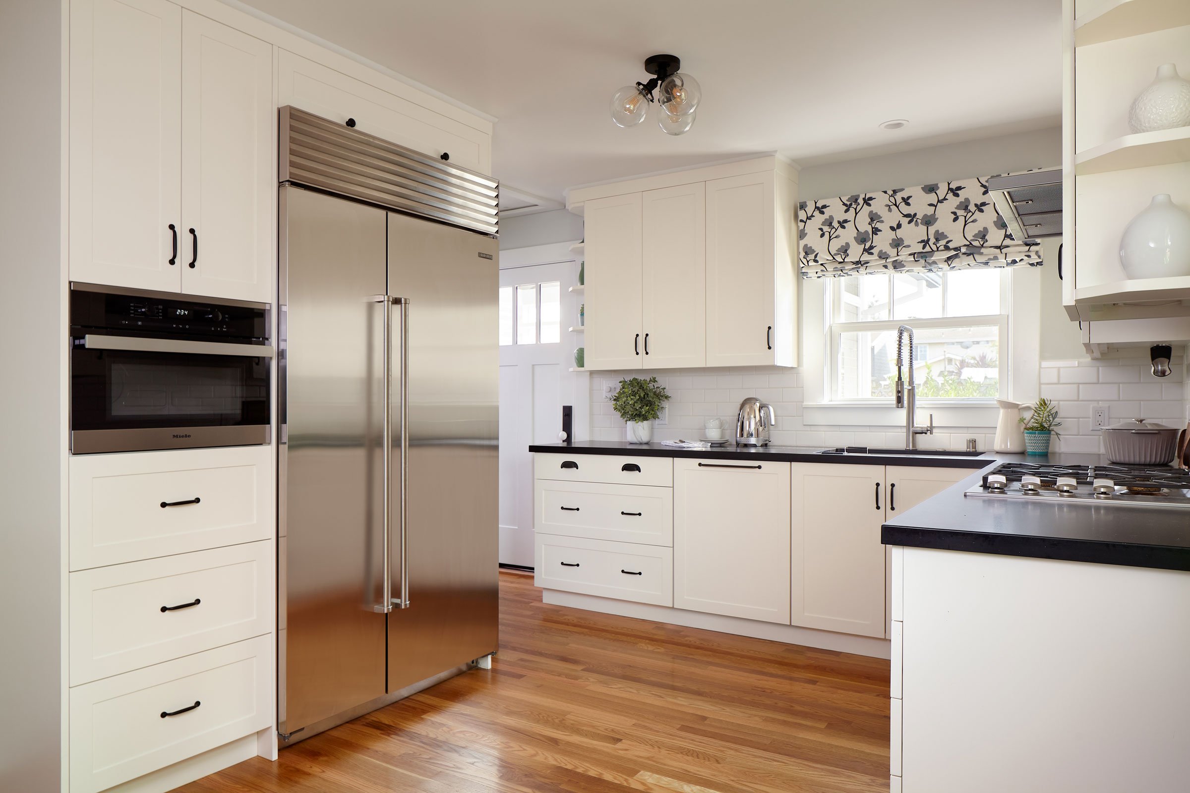 This charming kitchen in Santa Clara takes full advantage of vertical space to maximize storage.