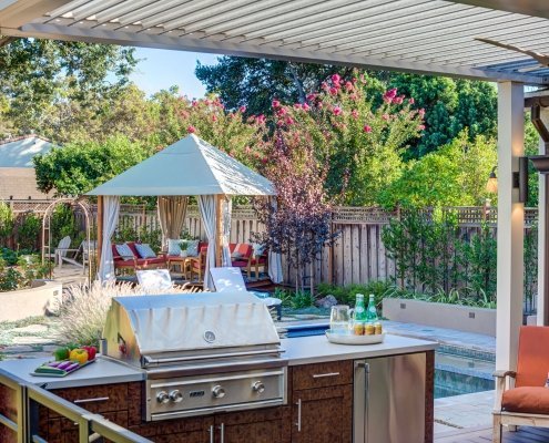 View of outdoor seating with chrome outdoor grill