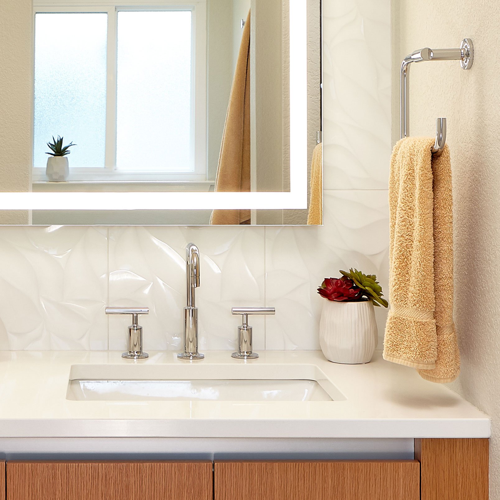 Bright sink with yellow towel hanging