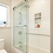 white bathroom and shower with shower shelves