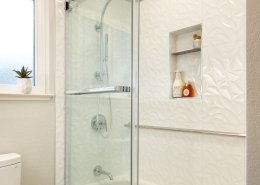 white bathroom and shower with shower shelves