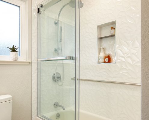 white bathroom and shower with shower shelves