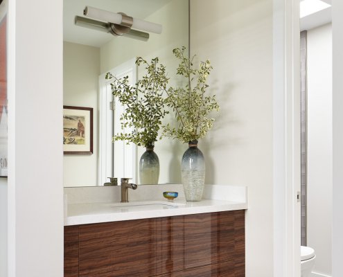A modern bathroom in Los Altos showcases a sleek wooden vanity.