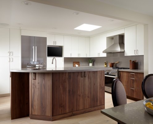 An island provides separation between the kitchen and dining room in this modern Los Altos home.