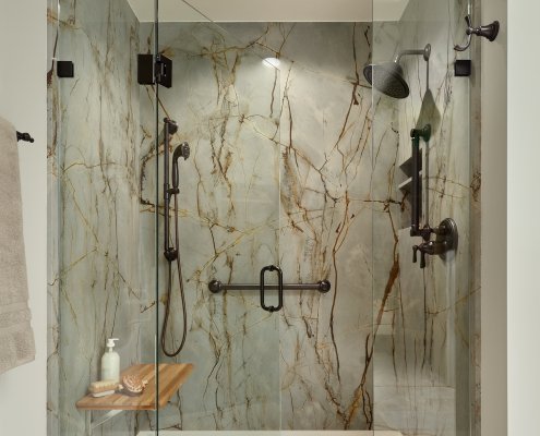 Aging in place is stylish in this Los Gatos primary bathroom, with a curbless shower and slab walls.