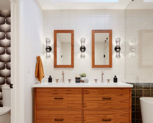 A San Jose bathroom features a mid-century inspired dual vanity and a skylight overhead.