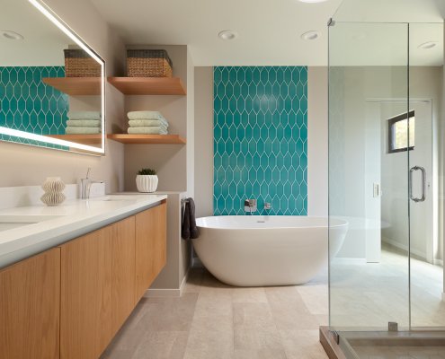 A modern, serene bathroom in San Jose features a colorful tile accent and floating vanity.
