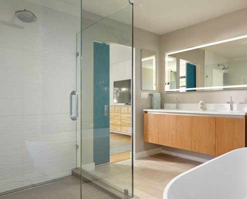 A modern bathroom in San Jose features an expansive, glass-enclosed shower and floating vanity.