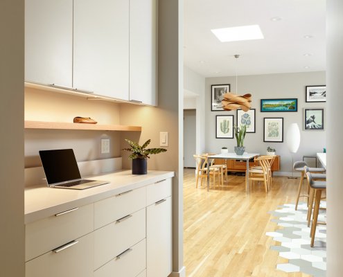 A modern hallway in San Jose offers sleek white storage and under-cabinet lighting.