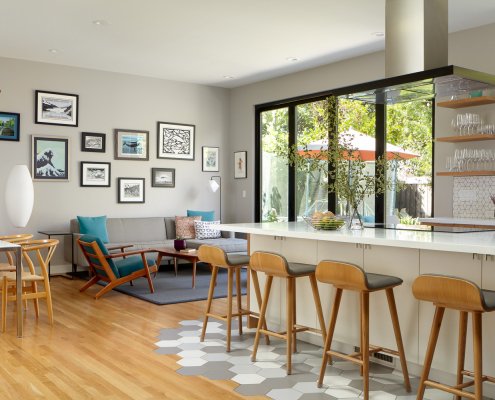 An open floor plan in San Jose with gray walls, warm hardwood floors, and geometric tiling.