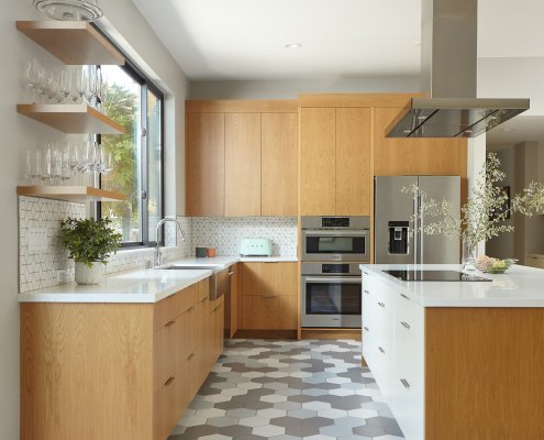 A playful, modern kitchen in San Jose features geometric tiles, an island, and open shelving.