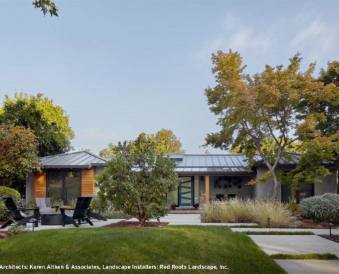A modern home in San Jose features large concrete pavers and a sleek firepit area.